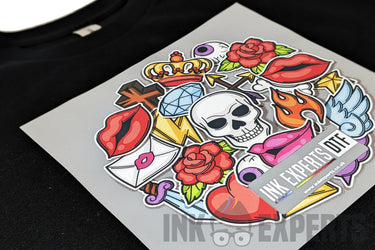 A sheet of vibrant tattoo-style stickers from InkMerges sample products 2, featuring a skull, roses, lips, flames, and a crown—ideal for adding a festive touch to your 4th of July shirt against a black fabric background.